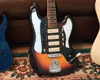 Rare 1960's Long Board mirror w/laminated neck, mother of pearl inlay, Amazing whammy action. Four independent single coil pickups. The wear is original.