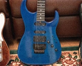 Hand signed- John Carruthers strat- style, Rock n Roll dream Axe. Blue with natural grain. Custom Carruthers wiring. EMG Hambucker and 2 EMG single coils. Mother of  Pearl inlay with locking nut.