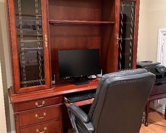 Desk shelves office chair and computer