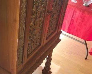 Antiqued carvwd liquor cabinet