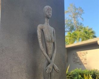 - Etched texture
The contemporary profile of the Lottie statue has a mid-century modern vibe. Made of composite in a bronze finish, the dark brown sculpture, which has a ruddy surface that makes it appear as if it has been forged from hammered metal, was designed by Raymond Waite.