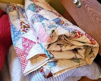 Lots of quilts, blankets, handmade rugs. 