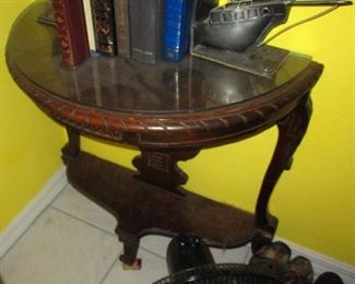 Carved mahogany console table with unusual heavy metal book ends representing the bow and stern of  a wrecked ship.