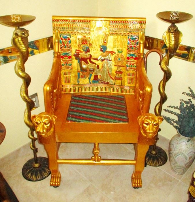 The Sun God: Gilded high quality, hand crafted exact reproduction of King Tut's throan chair as was recovered from his burial tomb and the original now sits in a Museum in Egypt. These cost about $2500.- new but this one is more affordable and you may never have another opportunity to own one from an estate sale.