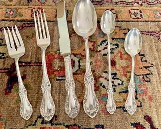 Detail:  Setting of Sterling flatware "Wild Rose" by International Sterling , (rug just for show.)