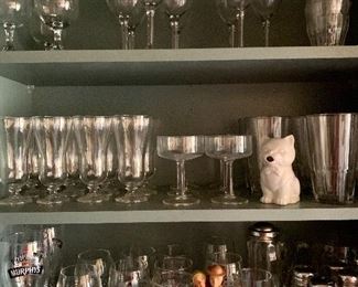 Miscellaneous glassware in over the kitchen counter cabinets.