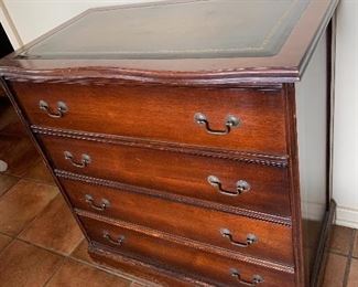 Leather top mahogany chest.