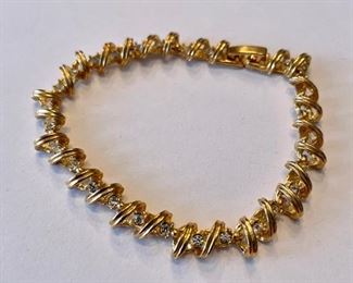 Gold bracelet with diamond accents.