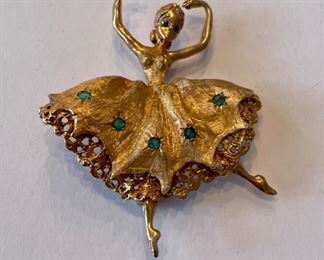 Ballerina pin with emerald and sapphire accents.