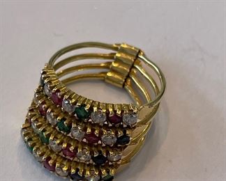 Gold ring with diamond, ruby and emerald accents.