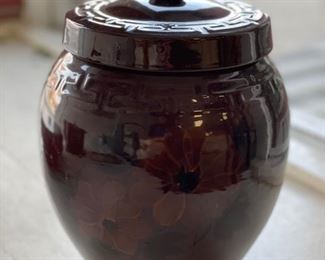 Lidded brown jar with Greek key trim and floral design. Photo 1 of 2.