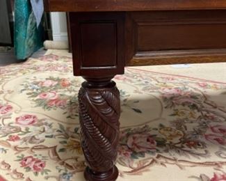 Cocktail table with class top and carved wood legs. Measures 50” x 30” x 18”. Photo 2 of 2.