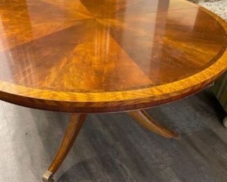 Mahogany pedestal dining table with satinwood banding. Measures 60” D. Has one 21” leaf. Measures 30.5” H with 28” clearance. Photo 1 of 2.