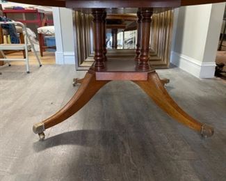 Mahogany pedestal dining table with satinwood banding. Measures 60” D. Has one 21” leaf. Measures 30.5” H with 28” clearance. Photo 2 of 2.