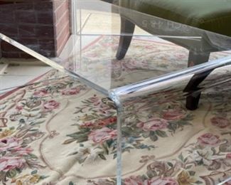 Lucite table. Measures 44” x 24” x 16”.