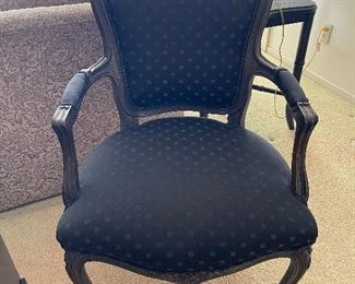 One of two black Bergére chairs