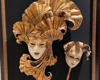 Framed Venetian masks. Measures 26" W x 32" H.