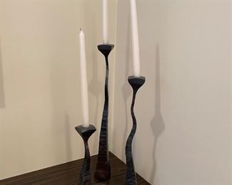 Set of three metal candlesticks.