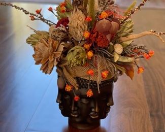 Faux flower arrangement in Buddha Faces vase. Photo 2 of 3.