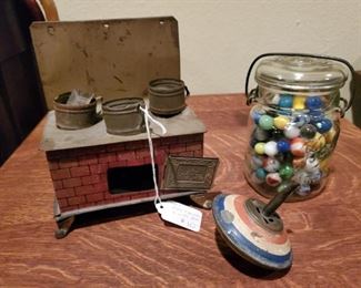 Tin litho stove and jar of marbles