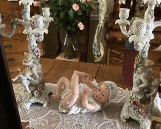 . . . a piano baby amidst two ornate candle holders