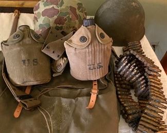Military canteens, helmets, nap sack and ammo belt.