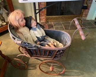Vintage doll carriage with dolls.