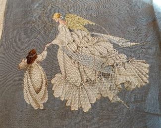 Unframed needlework.