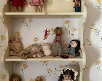 Dolls on shelf.