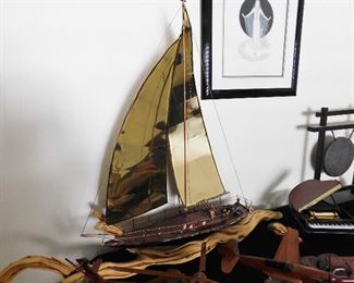Brass boat set on driftwood