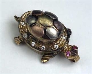 For your consideration is this 14K Gold & Simulated Ruby/Diamond Turtle Locket.  Marked and jeweler tested.  Very neat piece with moving legs and opening locket on top.  Original Retail Price $499.  Weighs approx. 6.7 grams.