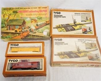 1129 LOT OF TYCO MODEL TRAINS/BUILDING KITS. LOT INCLUDES TWO TYCO HO GAUGE MODEL TRAINS & THREE BUILDING KITS TWO ARE OPERATING CROSSING GATE, ONE IS FREIGHT UNLOADING DEPOT
