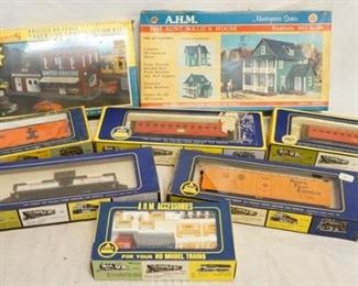 1157 LOT OF AHM TRAIN MODELS/BUILDING KITS. LOT INCLUDES 5 HO GAUGE, ONE MINIATURE CONSTRUCTION W/ DUMP TRUCK MODEL & TWO BUILDING KITS ONE OF WHICH IS SEALED IN BOX. 

