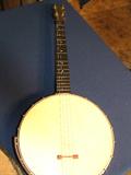 Olympian model four string banjo.