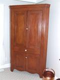 Raised panel cherry corner cupboard.