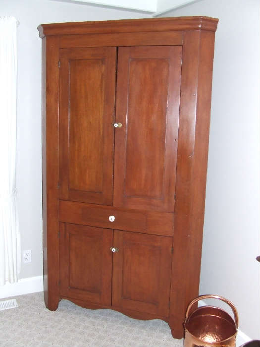 Raised panel cherry corner cupboard.