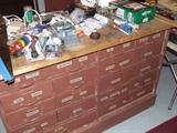 Roll about work bench cabinet with many metal drawers.
