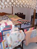 Pencil post four poster canopy bed. Nice selection of quilts.