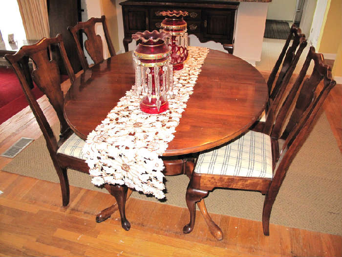 Fine cherry dining table with six Chippendale style chairs including two king arm chairs.