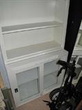 One of two enamel dental or doctor office cabinets.