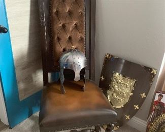 Vintage Medieval wooden throne chair and heavy metal helmet and shield