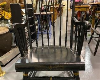 Antique low rise rocking chair. Black with gold trim.