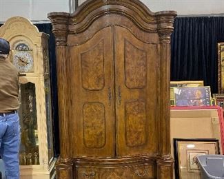 Solid wood armoire with scrolled columned sides. Base has huge drawer. Hinged doors with three interior shelves. Overall dimensions 55x90x29.  Lower base dimensions 55x16x29( included in overall dimensions)