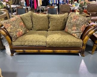 Bahama style oversized sleigh design sofa. Rattan/leather frame. Two large seat cushions .pillow back Browns/tans/florals.  98” long x40 ‘ deep x 30” high. Seat height 18 “