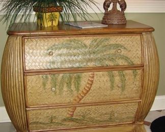 Bombay solid wood chest with three drawers. Rattan finish with hand painted palm tree. Solid maple wood top. Dimensions: 39 1/2 “ w x19 “ deep x 35 1/2 “ high.