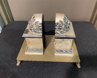 Ornate book ends on metal tray. Set of two. Weathered tan with weathered grey .