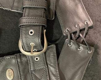 Harley Davidson Chaps  black leather  Ladies with lace up back waist and belt buckle Front waist full zippered legs Women ‘ XL.  MORE Harley clothing available. Most all NEW- NEVER WORN