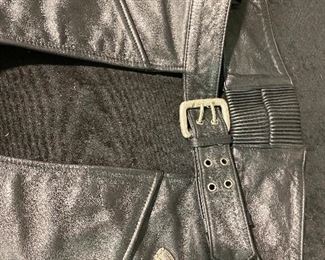 Harley Davidson Black leather chaps. men’s X Lg. Elastic back waist. Front Belt buckle front .side leg zippers Botton half leg with snaps