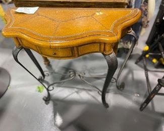 Slim hall  table with wrought iron legs.  Leather look .one drawer