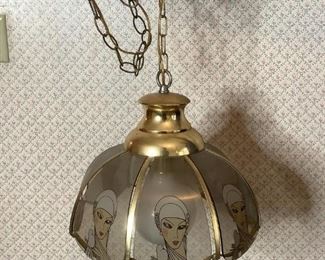 Art Deco Style Hanging Lamp
Brass colored metal with glass panels. Art Deco style hanging lamp on chain. Glass panels depict lady holding dove. Plugged in & powers on.